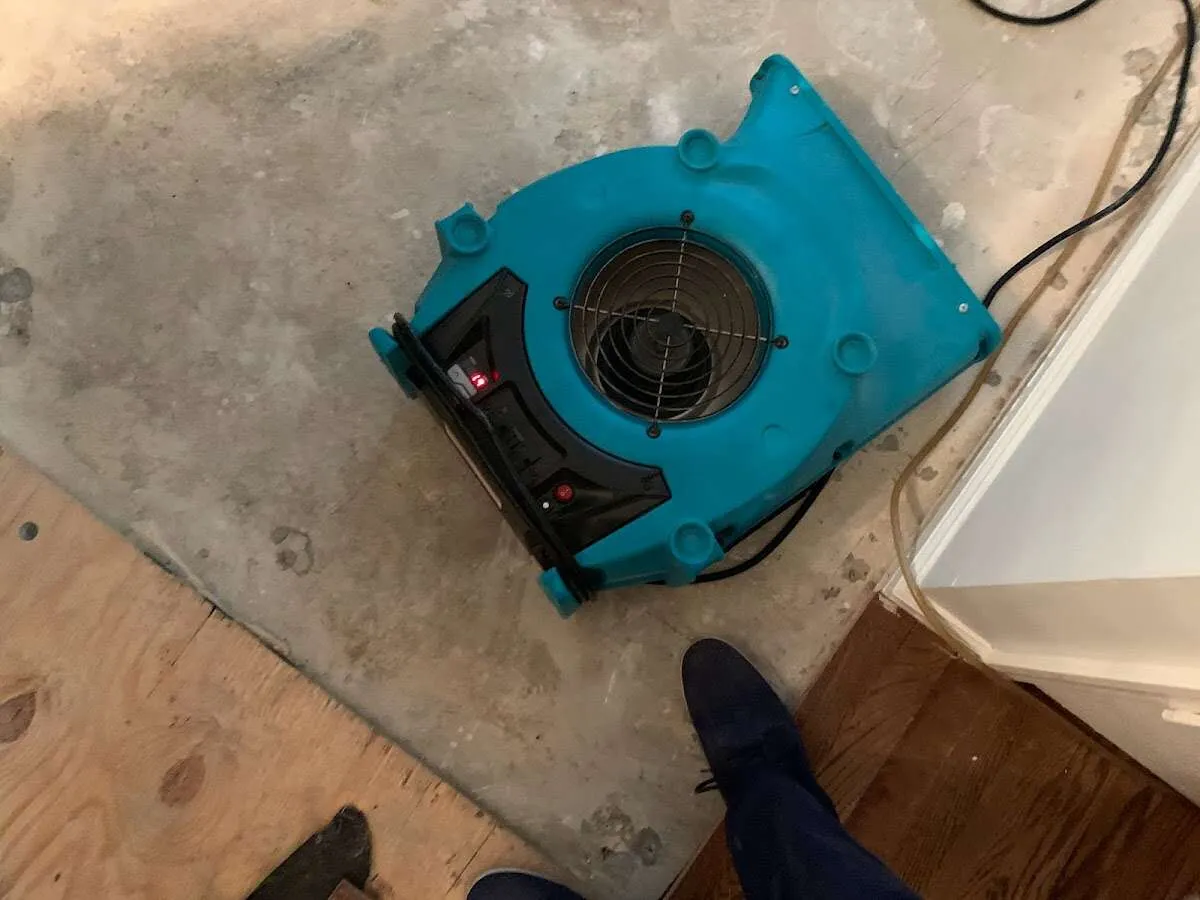 Air mover drying subfloor during Commercial Water Damage Restoration in East Pennsboro